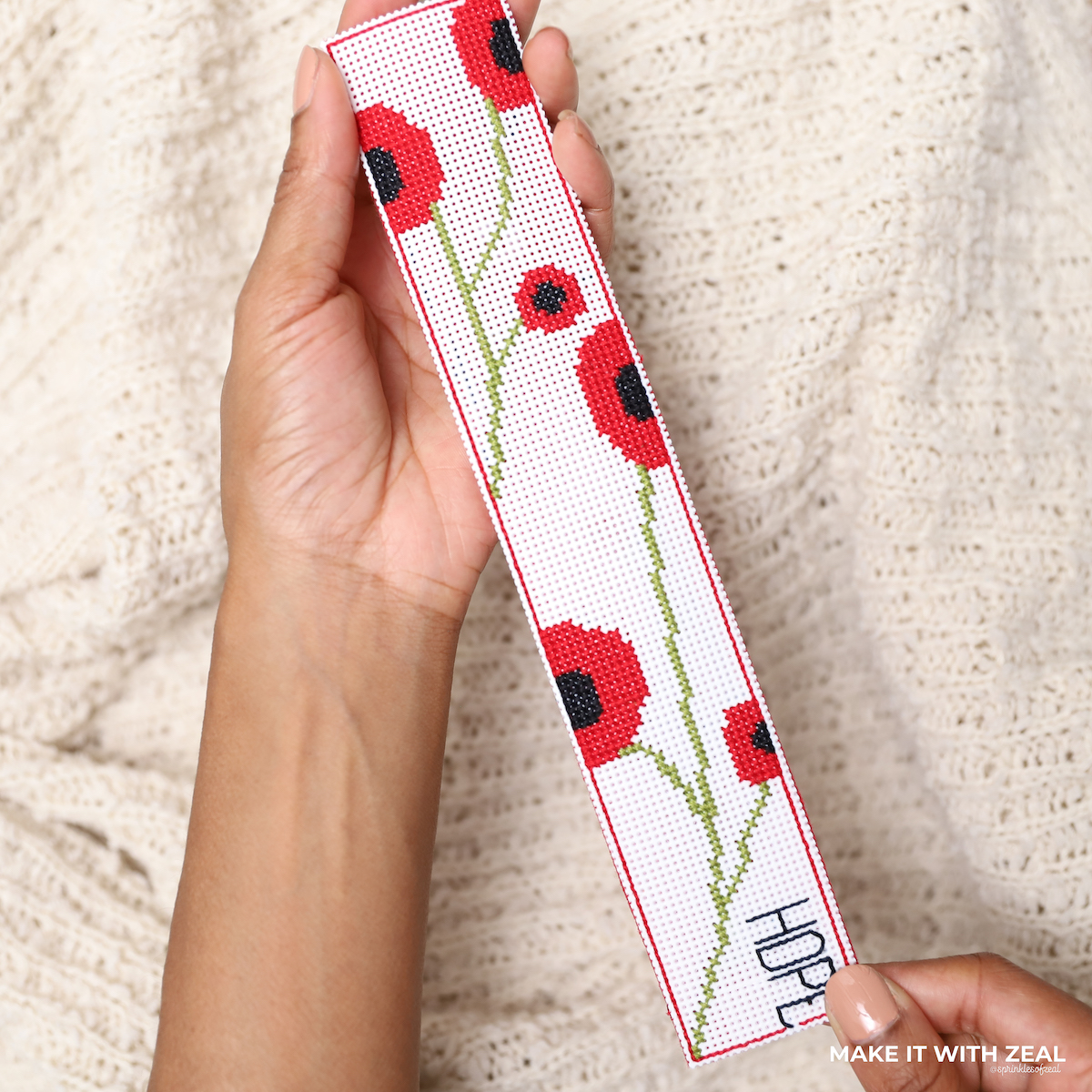 Poppies Cross Stitch bookmark made by Danielle Webb @sprinklesofzeal #freecrossstitchchart #freecrossstitchbookmark #crossstitchbookmark #perforatedcanvasideas #perforatedcanvas #freecrossstitchchart #handmadebookmark #makeitwithzeal #cloverusa #size24tapestryneedle #cloverrotarycutter #backstitching #Howdo youstartathreestrandcrossstitch? #Whatcanyoudo withcrossstitching?