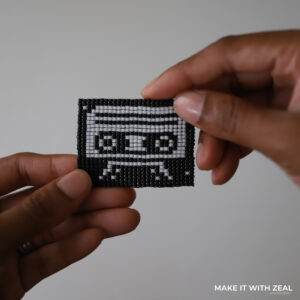 A bead loom earrings tutorial to create a 80s cassette tape using a bead loom by sprinklesofzeal #beadedjewelrytomake #beadedjewelry #beadingloom #loombeadingpatterns #beadedjewelrydesign #miyukibeads #miyukiseedbeads #1980sjewelry #beadloomearringpatterns #tohobeads